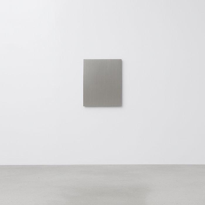Blank square stainless steel gallery plaque on a white wall.