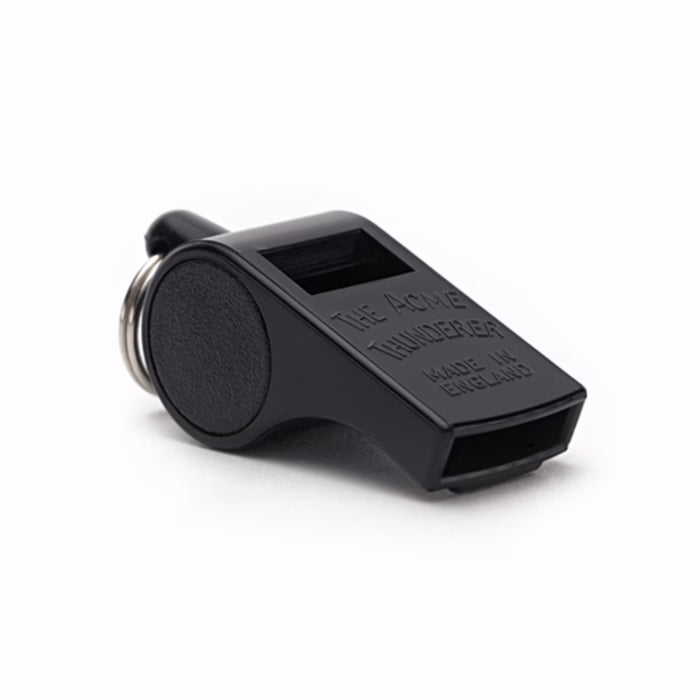 Black Acme Thunderer plastic pea whistle with a metal keyring, featuring embossed text on a white background.