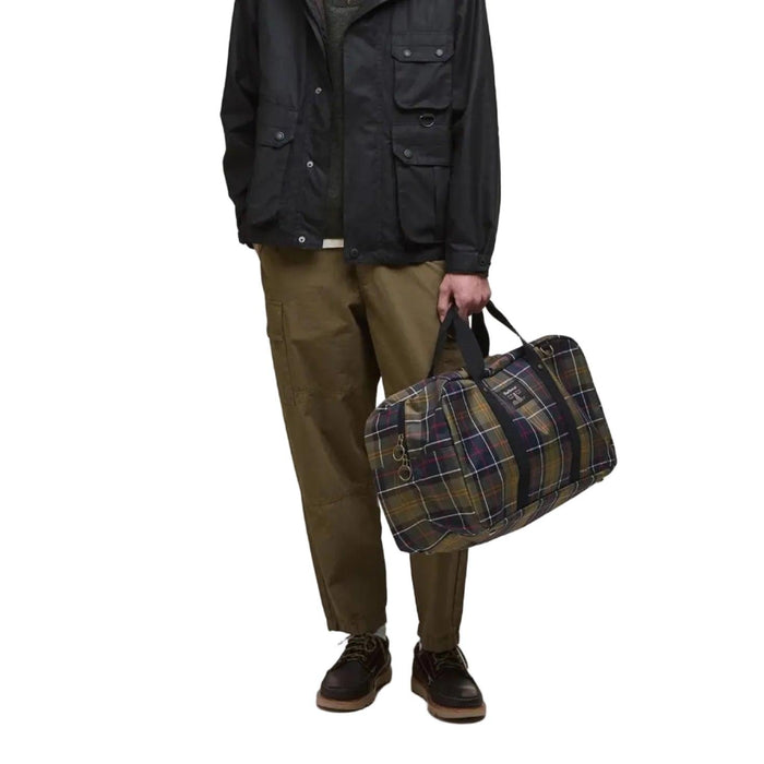 Barbour Torridon holdall in classic tartan print with black carry handles and a front logo badge.