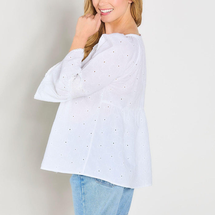 White cotton eyelet peasant top with 3/4 bell sleeves and a relaxed, breezy fit.