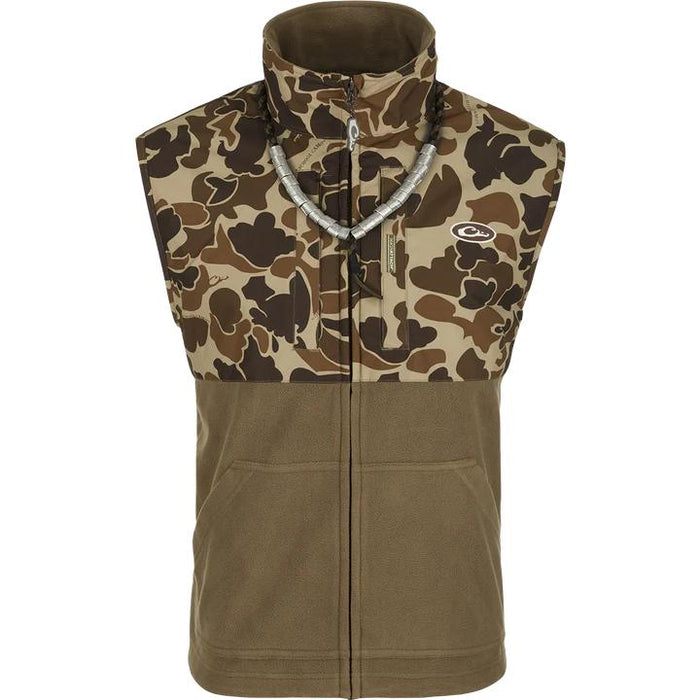 Drake MST Eqwader hunting vest with camo upper, olive fleece lower, zippered chest pockets, and duck call lanyard.