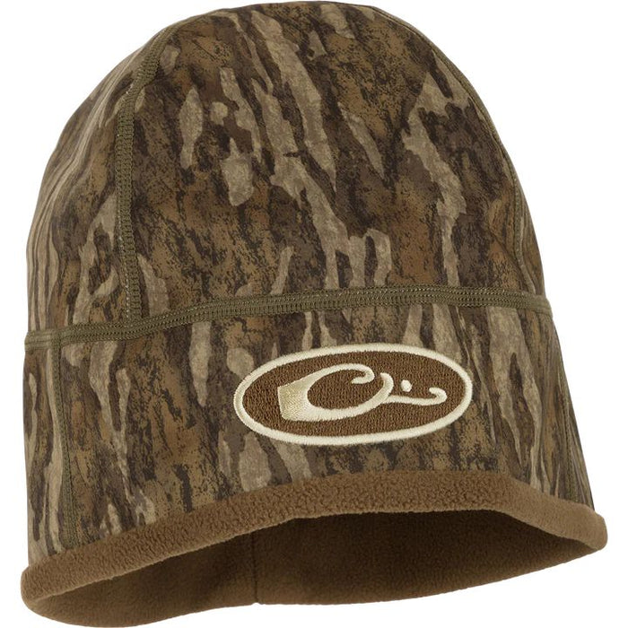 Drake Waterfowl MST Windstopper beanie in camouflage print with a brown fleece lining and embroidered logo patch.