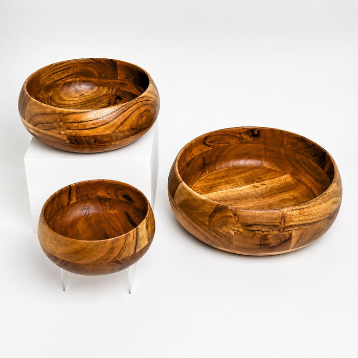 Set of three handcrafted wooden bowls with rich grain patterns and a smooth, polished finish in assorted sizes.