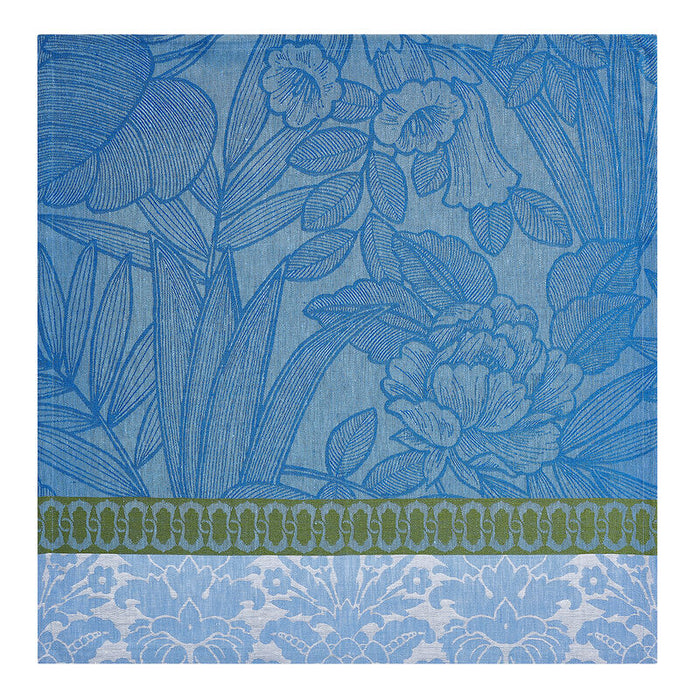 Blue jacquard linen napkin featuring a tropical floral pattern with a decorative green and white border.