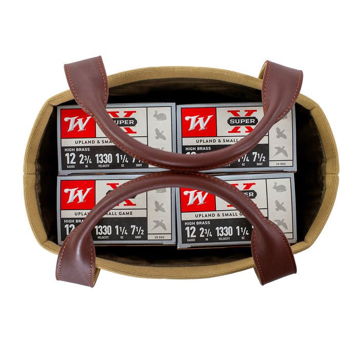 Tan canvas and brown leather shell carrier holding four boxes of 12-gauge shotgun shells, viewed from above.
