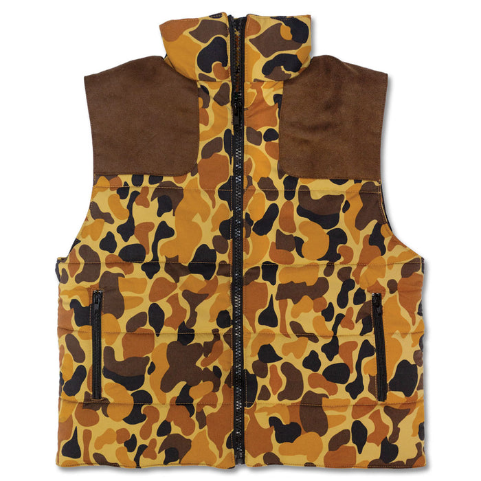 Kids' camo puffer vest with brown suede shoulder patches, a full-length black zipper, and two zippered side pockets.