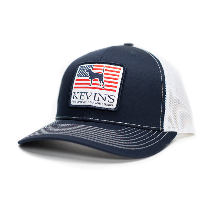 Navy blue and white Richardson 112 trucker cap featuring a Kevin's pointer dog and American flag patch.