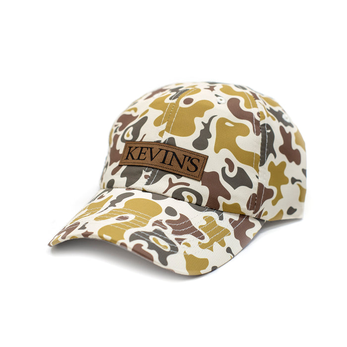Duck camo performance cap with a brown suede Kevin's logo patch and unstructured low-sweep profile.
