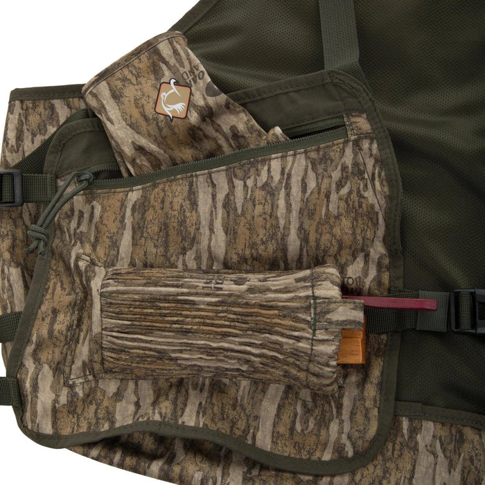 Ol' Tom turkey hunting vest in camo print featuring an external slate call pouch and durable rip-stop fabric construction.