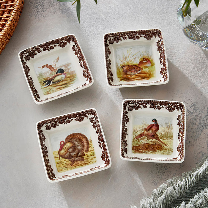 Set of four 3-inch square porcelain dishes featuring woodland animal illustrations and a brown floral border.