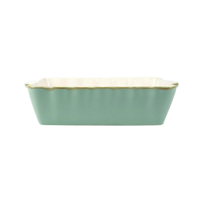 Vietri medium rectangular stoneware baker in sage green with a scalloped edge and cream interior.