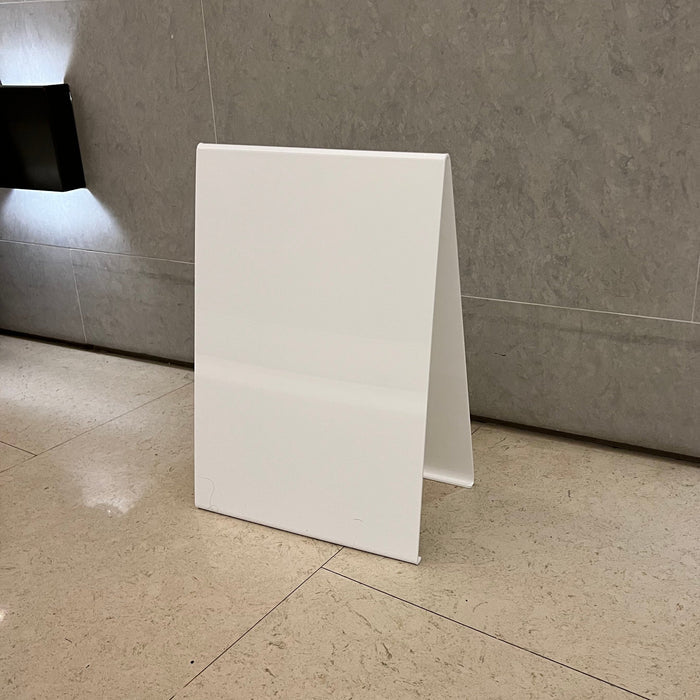 Right angled view of a blank white opaque acrylic A-frame sign.
