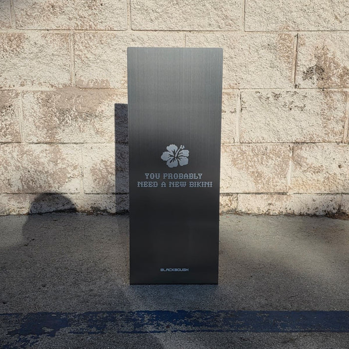 Front view of a slanted stainless steel sign with The Peninsula Tokyo lettering.
