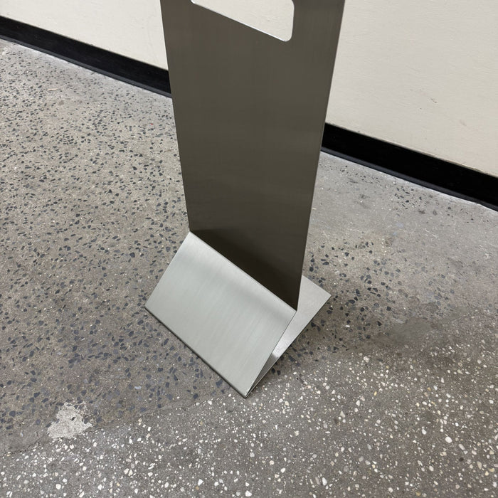 Close-up of the folded base of a stainless steel floor sign.