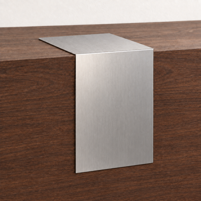 Brushed stainless steel waterfall tabletop sign draped over the edge of a wooden counter.