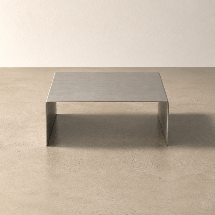 Front view of a narrow stainless steel display riser.