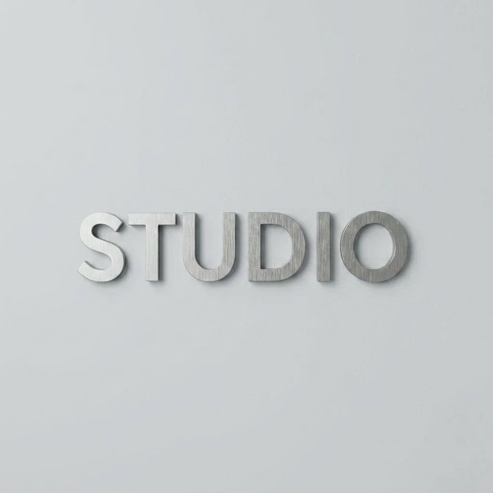 Front view of aluminum wall letters spelling Studio.