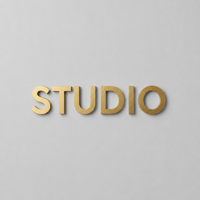 Brass wall letters spelling Studio.