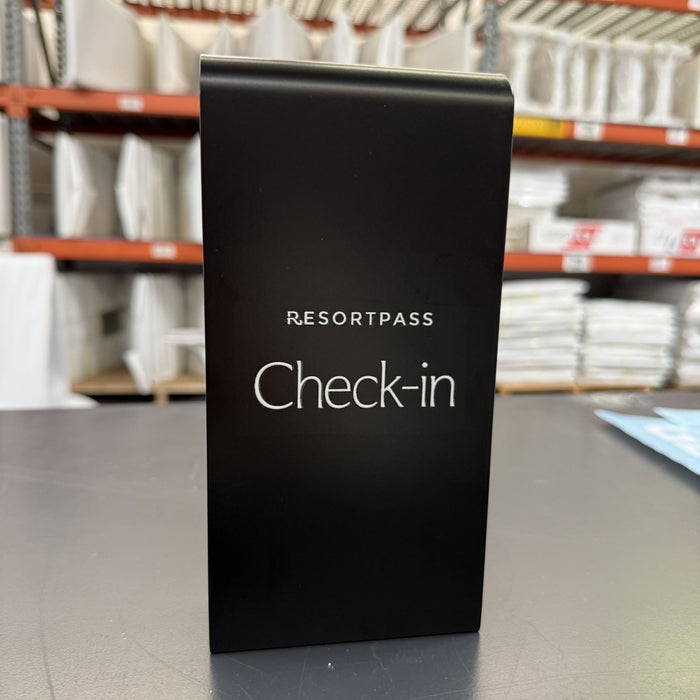 Black sign clip with ResortPass Check-in lettering hanging from a rail.