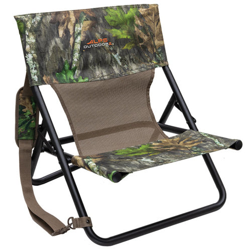Low-profile camo hunting chair with a black steel frame, mesh back, and padded shoulder carry strap.
