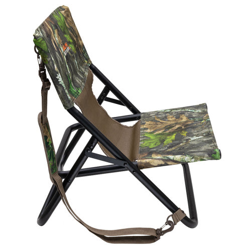 Low-profile camo turkey hunting chair with a black steel frame and padded shoulder carry strap.