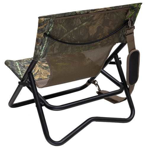 Low-profile camo hunting chair with a black steel frame, mesh back, and padded shoulder carry strap.
