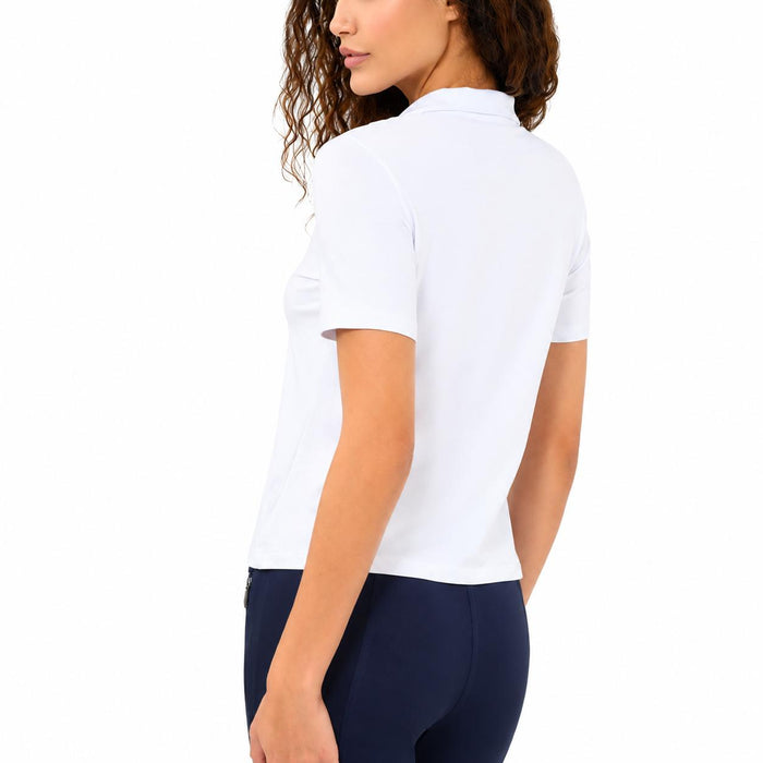 Woman wearing a white, short-sleeved Pima cotton zip-up top with a high collar and slim, tailored fit.