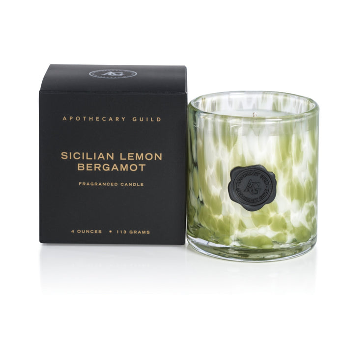 Apothecary Guild Sicilian Lemon Bergamot candle in a green speckled glass jar with a black wax seal next to its box.