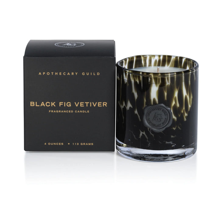 Apothecary Guild Black Fig Vetiver candle in a decorative black opal glass jar with a wax seal next to its gift box.