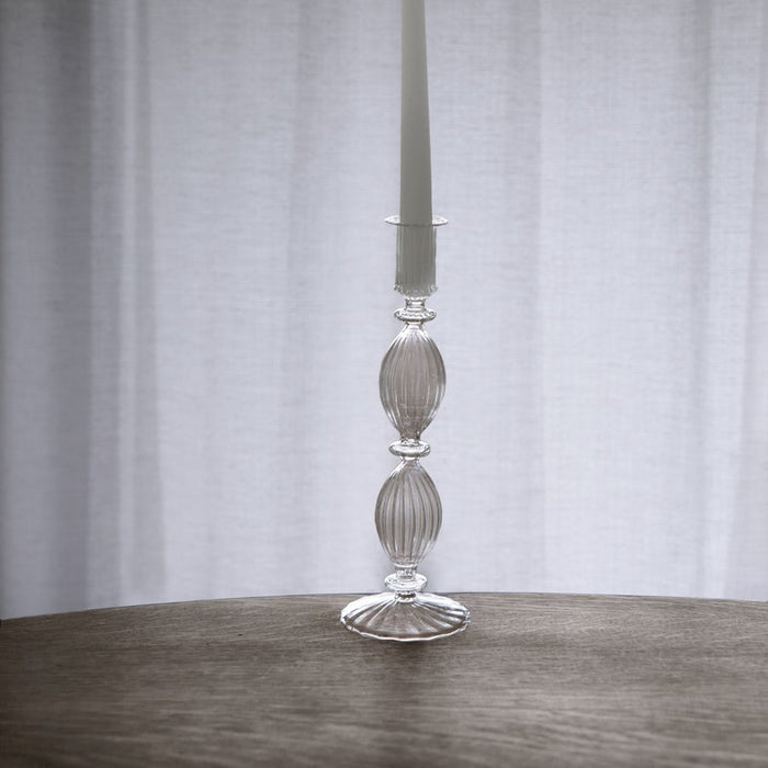 Beatriz Ball 10-inch clear glass Cambridge candlestick holder with ribbed, elegant design on a wooden table.