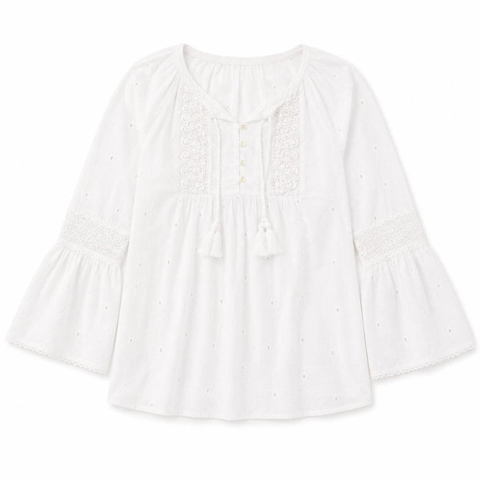 White cotton peasant top with eyelet details, 3/4 bell sleeves, lace trim, and a tassel-tie neckline.