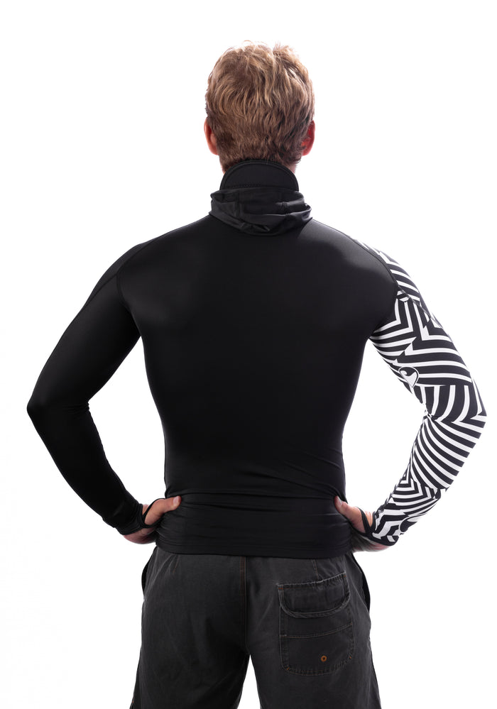 Rear view of a man wearing the Waihana Black Carvico Hooded Surf Rashguard featuring a black body with a striking black-and-white geometric patterned right sleeve and integrated hood.