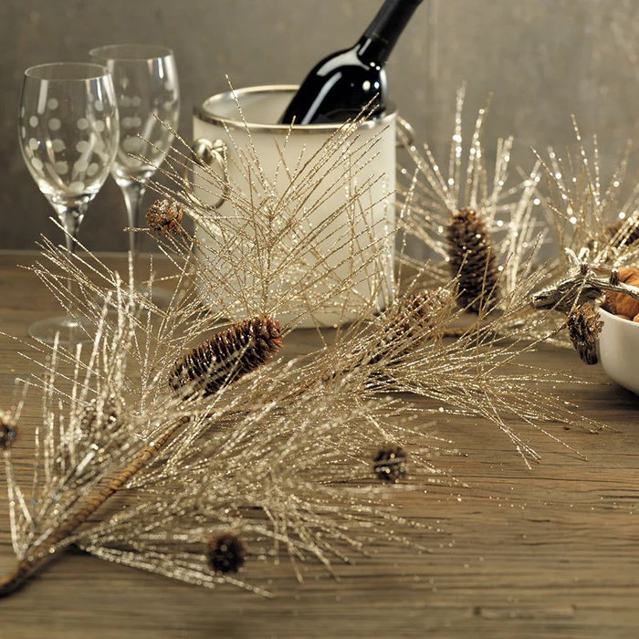 Champagne-toned spruce garland with pinecone accents, perfect for elegant holiday table decor.