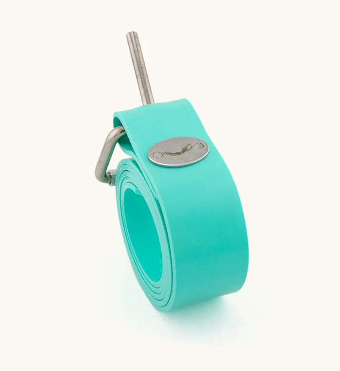 Rolled turquoise silicone Crystal River dive weight belt with stainless steel pin buckle and Waihana brand emblem, displayed upright on a white background.