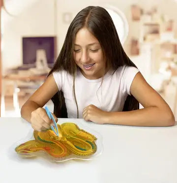 Girl using dissection tools on Dissect It Rattlesnake Super Lab synthetic dissection toy for biology learning.