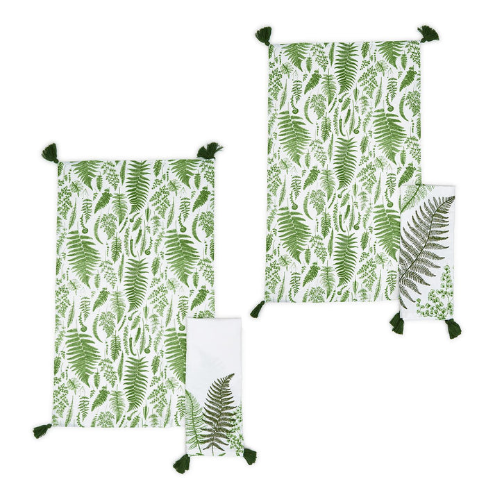 Set of two white cotton dish towels featuring green fern botanical prints and decorative corner tassel accents.