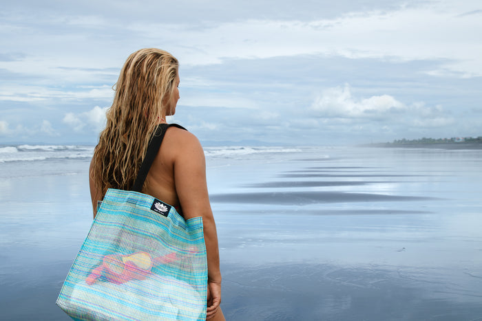 Woman carrying the Gili Gear Tote Bag over her shoulder at the beach