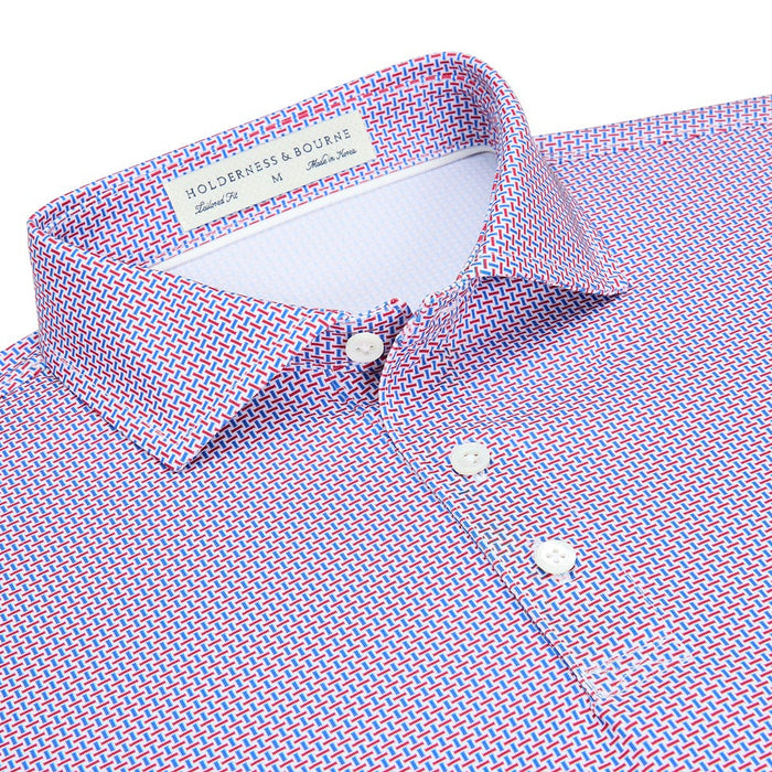 Holderness & Bourne Davis polo in white with a red and blue geometric pattern, spread collar, and shell buttons.