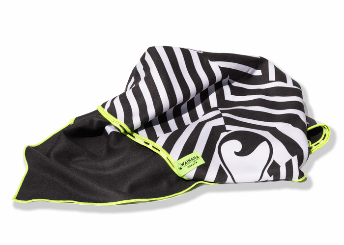 Waihana HydroTech Towel in black and white tribal graphic print with neon lime green trim and branded label, loosely folded on a white background.