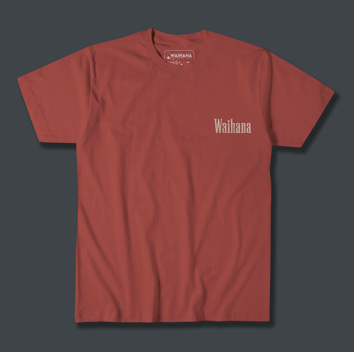 Waihana Island Original Premium Pima T-Shirt in Burnt Earth red, displayed flat against a dark grey background with a small Waihana wordmark on the chest.