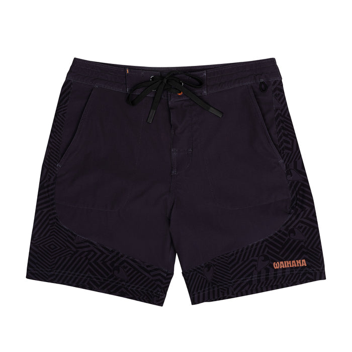 Waihana Jet Black W1-PRO board shorts laid flat on a white background, showing dark charcoal fabric with tonal geometric patterned side panels, black drawstring, and orange Waihana branding.