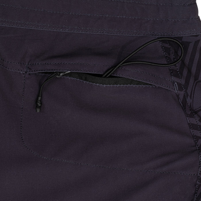 Close-up of the zippered side pocket with black drawstring cord on the Waihana Jet Black W1-PRO board shorts, showing stitching and fabric texture.