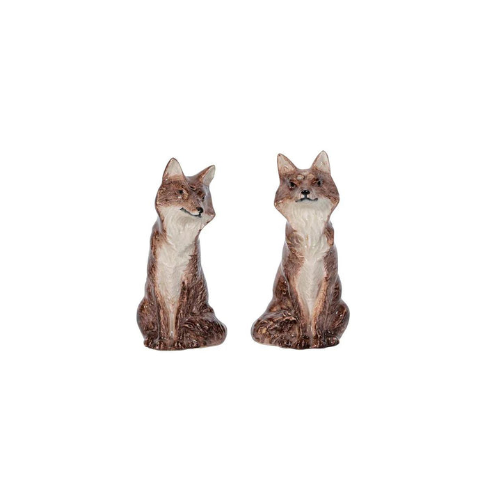 Set of two brown and white ceramic fox salt and pepper shakers with a whimsical, sculptural design.