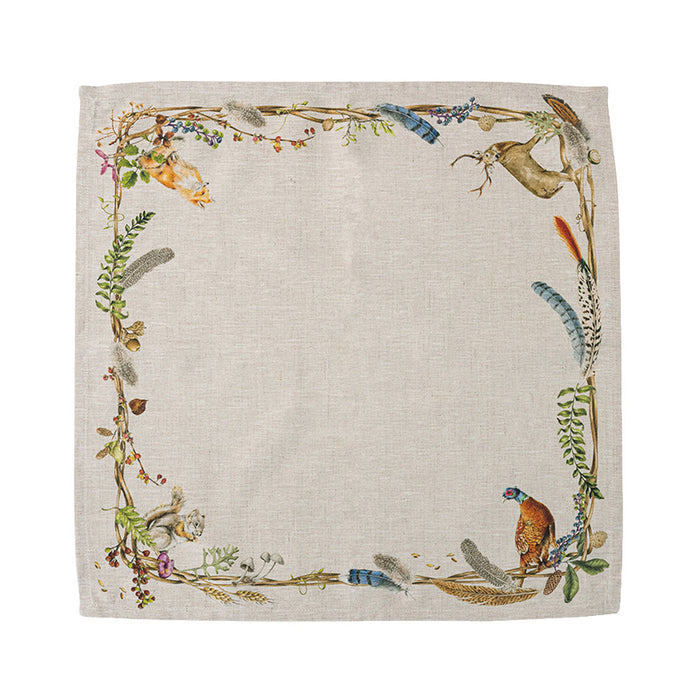 Square linen napkin featuring a woodland border with a stag, pheasant, fox, and squirrel on a natural beige background.