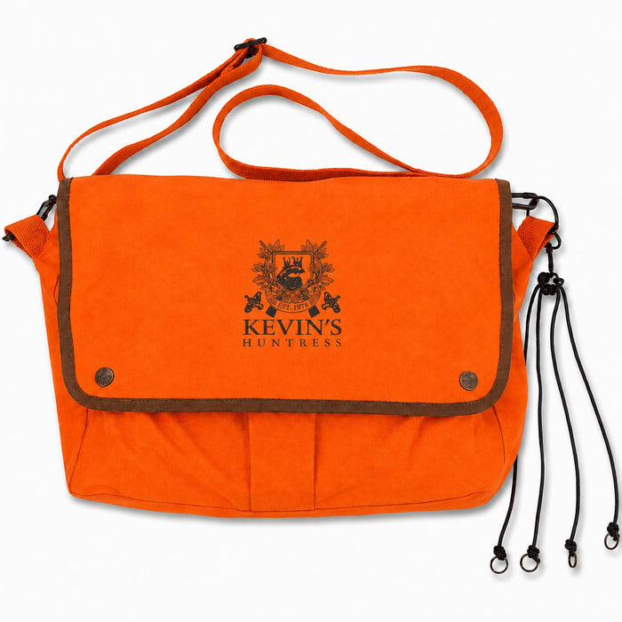 Bright orange Kevin's Huntress game bag with brown trim, adjustable shoulder strap, and black logo on a white background.