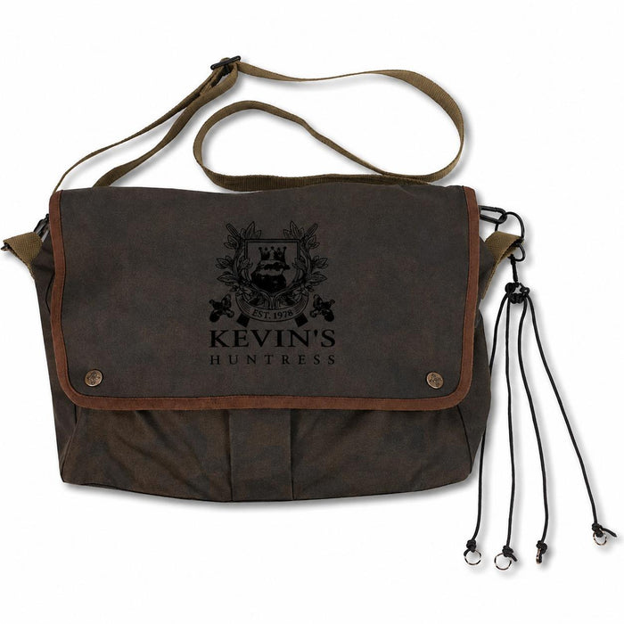 Brown waxed canvas Kevin's game bag with an adjustable shoulder strap, leather trim, and a black logo on the front flap.