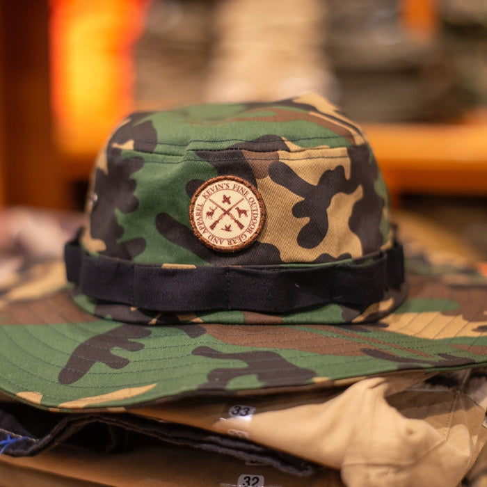 Camo cotton twill boonie hat with a full brim and a round Kevin's Fine Outdoor Gear patch on the front.
