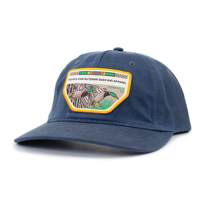 Navy blue waxed cotton five-panel cap featuring a Casey Underwood mallard duck patch and pre-curved visor.