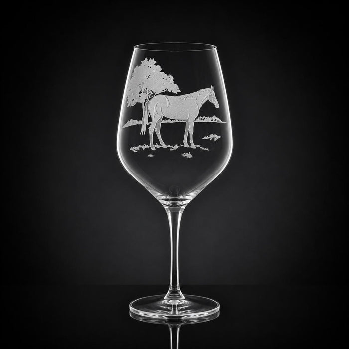 23 oz crystal red wine glass featuring a detailed, sand-etched horse design against a dark background.