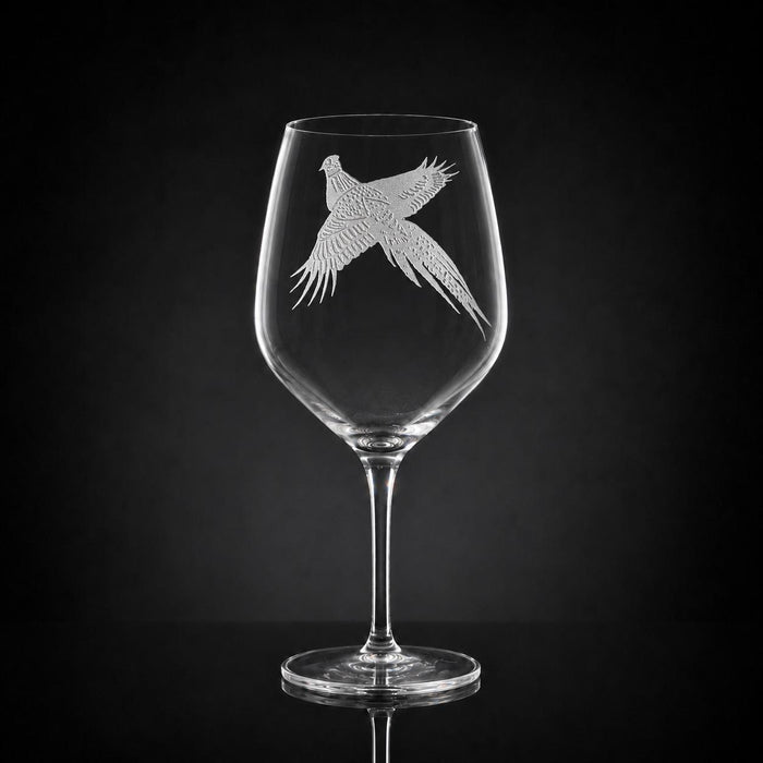 23 oz crystal red wine glass featuring a detailed, sand-etched pheasant design against a black background.